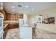 Well-lit kitchen with granite countertops, ample cabinet space, and a central island at 8840 Arroyo Azul St, Las Vegas, NV 89131