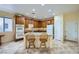 Traditional kitchen with wooden cabinets, granite countertops, double oven, and a central island with bar stool seating at 8840 Arroyo Azul St, Las Vegas, NV 89131