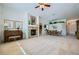 Open-concept living room with a fireplace, piano, and seamless flow into the dining area at 8840 Arroyo Azul St, Las Vegas, NV 89131