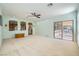 Expansive living room with neutral carpet, recessed lighting, ceiling fan, backyard access, and seamless flow to other rooms at 8840 Arroyo Azul St, Las Vegas, NV 89131