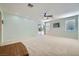 Bright and spacious living room with plush carpeting, ceiling fan, recessed lighting, and sliding door to the backyard at 8840 Arroyo Azul St, Las Vegas, NV 89131