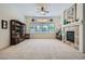 Inviting living area with a cozy fireplace and ample natural light from the large windows at 8840 Arroyo Azul St, Las Vegas, NV 89131