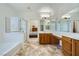 Spacious bathroom with dual sinks, soaking tub, glass shower, and an open layout connected to the main bedroom at 8840 Arroyo Azul St, Las Vegas, NV 89131