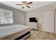 Neutral bedroom with ceiling fan and window, featuring a dresser and adjacent closet at 9050 W Warm Springs Rd # 1074, Las Vegas, NV 89148