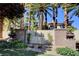Landscaped community sign for 'The Falls' with lush plantings and mature trees at 9050 W Warm Springs Rd # 1074, Las Vegas, NV 89148