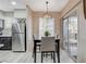 Dining area adjacent to the kitchen with modern lighting and sliding door at 9050 W Warm Springs Rd # 1074, Las Vegas, NV 89148