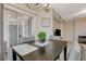 Cozy dining area features a dark wood table, soft gray chairs, and a sliding glass door at 9050 W Warm Springs Rd # 1074, Las Vegas, NV 89148