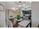 Open dining area with modern lighting, and an adjacent kitchen with stainless appliances at 9050 W Warm Springs Rd # 1074, Las Vegas, NV 89148