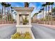 Community entrance monument with address number and palm tree-lined street at 9050 W Warm Springs Rd # 1074, Las Vegas, NV 89148