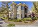 Beautiful two-story condo featuring a stucco exterior, manicured landscaping, and charming architectural details at 9050 W Warm Springs Rd # 1074, Las Vegas, NV 89148