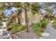 Well-maintained townhouse with lush landscaping and inviting walkway, nestled in a vibrant community at 9050 W Warm Springs Rd # 1074, Las Vegas, NV 89148