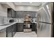 Modern kitchen featuring gray cabinets, stainless steel appliances, and white countertops at 9050 W Warm Springs Rd # 1074, Las Vegas, NV 89148