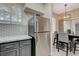 Modern kitchen with stainless steel refrigerator and adjacent dining area at 9050 W Warm Springs Rd # 1074, Las Vegas, NV 89148