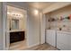 Well-lit laundry room area featuring washer, dryer and storage shelves for convenience at 9050 W Warm Springs Rd # 1074, Las Vegas, NV 89148