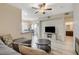 Inviting living room features modern ceiling fan, plank floors, and seamless flow into the dining area at 9050 W Warm Springs Rd # 1074, Las Vegas, NV 89148
