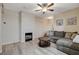 A comfortable living room with fireplace, plush couch and plank flooring at 9050 W Warm Springs Rd # 1074, Las Vegas, NV 89148