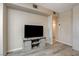 Bright living room features neutral walls, plank floors, and a modern entertainment center at 9050 W Warm Springs Rd # 1074, Las Vegas, NV 89148