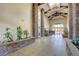 Elegant lobby with stone columns, tiled floors, and lush planters at 9050 W Warm Springs Rd # 1074, Las Vegas, NV 89148
