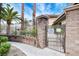 Community pool entrance with an ornate gate, brick columns and lush landscape at 9050 W Warm Springs Rd # 1074, Las Vegas, NV 89148