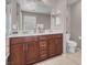 Bathroom features a double sink vanity with dark wood cabinets and a large mirror at 946 Belton Lake Ave, North Las Vegas, NV 89086