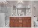 Bathroom showcases a double sink vanity with a shower and tub combo at 946 Belton Lake Ave, North Las Vegas, NV 89086