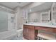 Bright bathroom features a vanity area, a shower over bath, and sleek finishes at 946 Belton Lake Ave, North Las Vegas, NV 89086