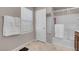 Bathroom featuring neutral walls, tiled flooring, a window, and a shower-tub combo at 946 Belton Lake Ave, North Las Vegas, NV 89086