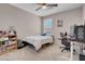 Bedroom with a ceiling fan, window, and desk area at 946 Belton Lake Ave, North Las Vegas, NV 89086