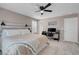 Cozy bedroom with neutral walls, ceiling fan, plush carpet, and a dedicated workspace area at 946 Belton Lake Ave, North Las Vegas, NV 89086