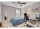 Bedroom with a ceiling fan, window, gaming chair, and desk setup at 946 Belton Lake Ave, North Las Vegas, NV 89086