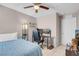 Bedroom featuring a gaming chair, a bed, and a ceiling fan at 946 Belton Lake Ave, North Las Vegas, NV 89086