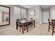 Cozy dining area featuring a modern table, bench seating, and natural light from nearby windows at 946 Belton Lake Ave, North Las Vegas, NV 89086
