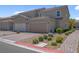 Charming two-story home featuring a tile roof, well-manicured landscaping, and a two-car garage at 946 Belton Lake Ave, North Las Vegas, NV 89086