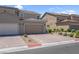 Desirable two-story home showcasing a tile roof, neat landscaping, and a spacious two-car garage at 946 Belton Lake Ave, North Las Vegas, NV 89086