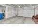 Spacious unfinished garage featuring high ceilings, ample storage potential, and a large garage door at 946 Belton Lake Ave, North Las Vegas, NV 89086
