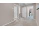 Spacious hallway with neutral carpet and paint, leading to bedrooms and bathrooms at 946 Belton Lake Ave, North Las Vegas, NV 89086