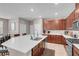 Spacious kitchen showcasing a large island, stainless appliances, and warm wood cabinetry at 946 Belton Lake Ave, North Las Vegas, NV 89086