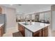 Open-concept kitchen with a central island and stainless steel appliances seamlessly connected to the living area at 946 Belton Lake Ave, North Las Vegas, NV 89086