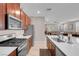 Modern kitchen seamlessly flowing into the living area, boasting a stylish design and stainless appliances at 946 Belton Lake Ave, North Las Vegas, NV 89086