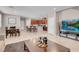 Spacious open-concept living room flows into kitchen, featuring modern decor and tile flooring at 946 Belton Lake Ave, North Las Vegas, NV 89086