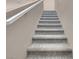 Carpeted staircase with neutral colored walls offers a safe and stylish transition between floors at 946 Belton Lake Ave, North Las Vegas, NV 89086