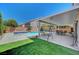 Inviting backyard features a sparkling pool, covered patio, and lush green lawn for relaxation and enjoyment at 9656 Paraiso Springs St, Las Vegas, NV 89139