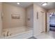 Cozy bathroom showcasing a soaking tub next to a door leading to the main bedroom at 9656 Paraiso Springs St, Las Vegas, NV 89139