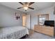 Comfortable bedroom with a ceiling fan, large window, and wood dresser at 9656 Paraiso Springs St, Las Vegas, NV 89139