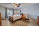 Comfortable bedroom with neutral tones, ceiling fan, and natural light from the window at 9656 Paraiso Springs St, Las Vegas, NV 89139