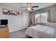 Cozy bedroom with neutral walls, plush carpet, large window and guitar display at 9656 Paraiso Springs St, Las Vegas, NV 89139
