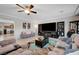 Open-concept living room boasts plenty of space, stylish furniture, and great flow for entertaining at 9656 Paraiso Springs St, Las Vegas, NV 89139