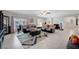 Spacious living room with ample seating, large windows, and tile flooring throughout the space at 9656 Paraiso Springs St, Las Vegas, NV 89139