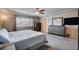Bright main bedroom featuring a ceiling fan, large window and ensuite bathroom for a relaxing retreat at 9656 Paraiso Springs St, Las Vegas, NV 89139