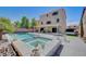 Relaxing backyard featuring a sparkling pool, integrated spa, covered patio, and a spacious concrete deck, ideal for outdoor living at 9656 Paraiso Springs St, Las Vegas, NV 89139